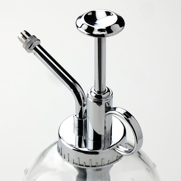 Elegant chrome plant mister with glass bottle, long spout, and trigger handle.