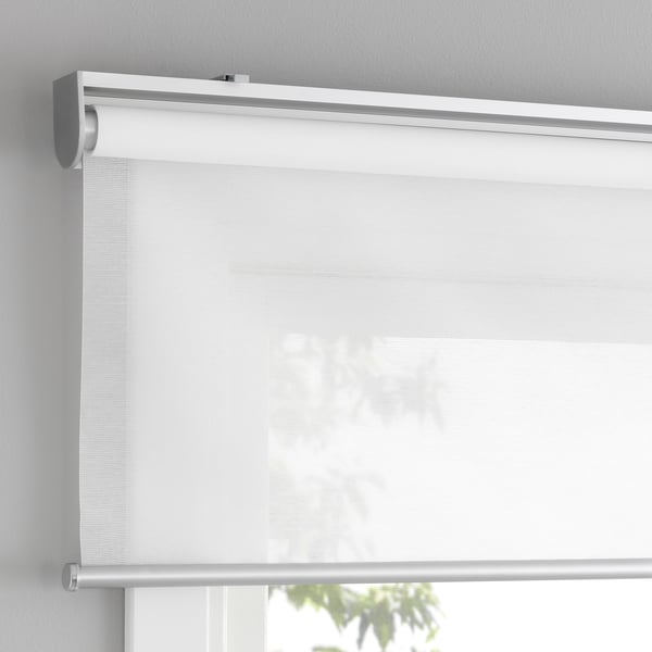 A cordless roller blind with soft-close, mounted above a window, allowing filtered light and safety.