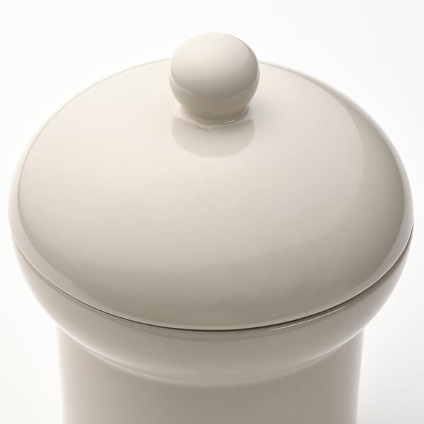 Off-white treat jar with lid.