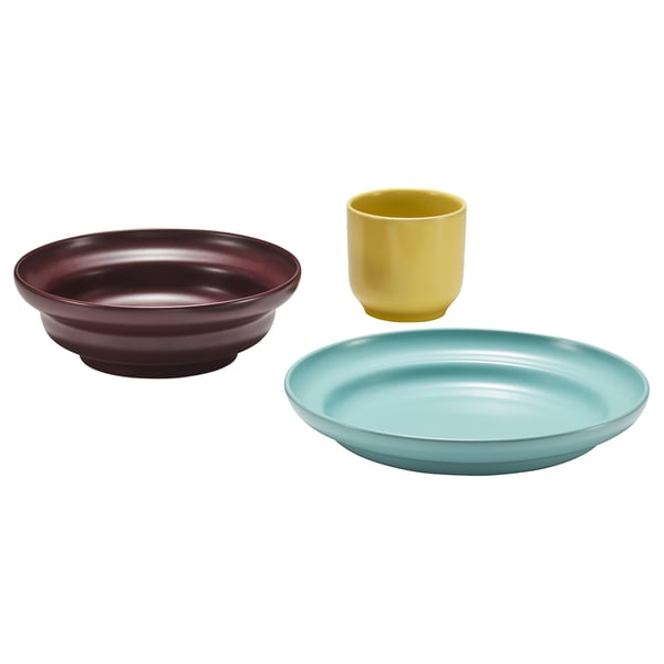 Three colourful ceramic items: red bowl, yellow cup, blue shallow plate.