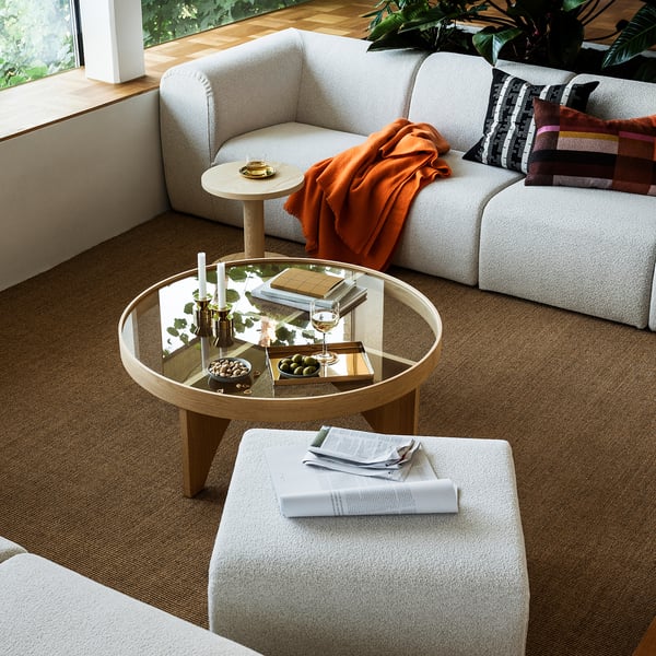 Sofa in white with stripes, games, & snacks, cosy carpet.
