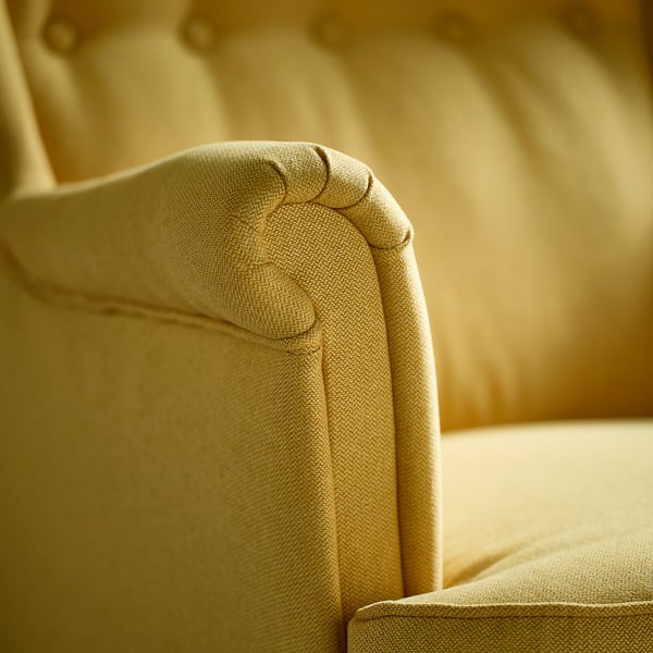 Close-up of a high-quality upholstered chair armrest, showcasing its soft, textured fabric and sturdy design.
