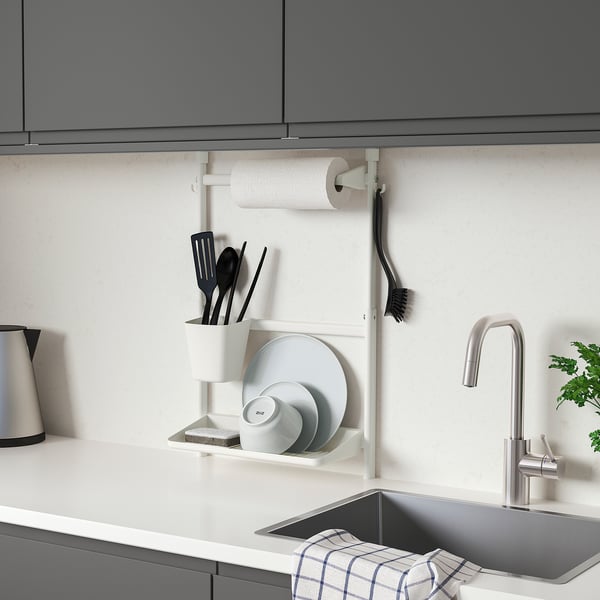 Modern kitchen with wall-mounted SUNNERSTA organiser: small, white, steel, holding dishes, utensils, and paper towels.
