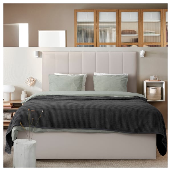 Modern bedroom with TJÅLLE headboard, soft fabric, dark & light grey bedding, minimalist decor.