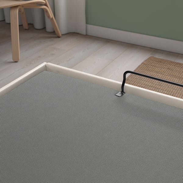 Modern bed with fabric cover, showing gas spring mechanism for smooth lid operation.