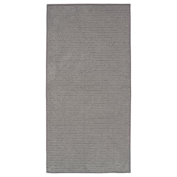 A TOFTBO grey bath mat. It a textured, rectangular design made from recycled polyester materials.