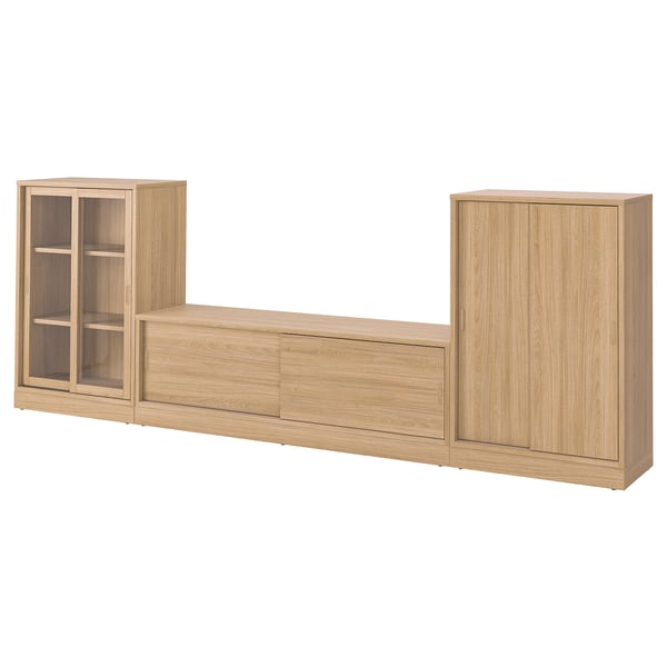 A light wood-colored TONSTAD storage set with a tv bench, featuring glass and solid wooden doors and adjustable shelves.
