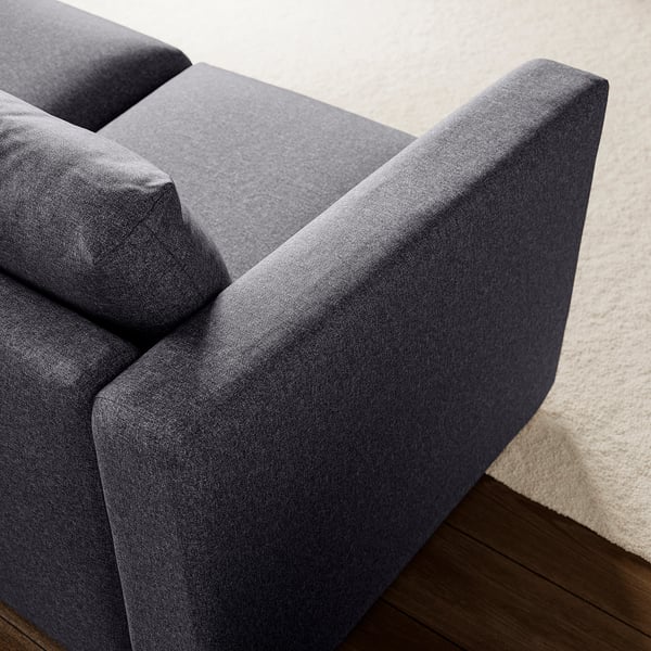 Dark grey fabric sofa close-up, showcasing clean lines and quality fabric.