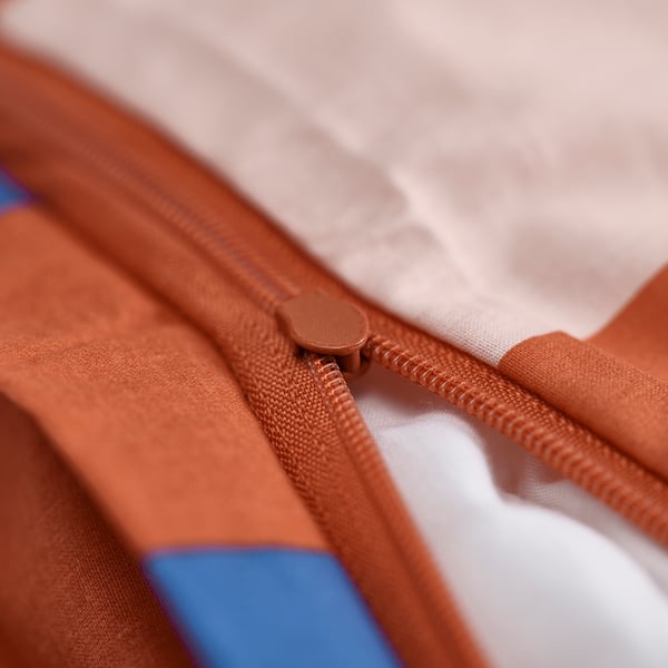 Close-up of brown zip on item of clothing.