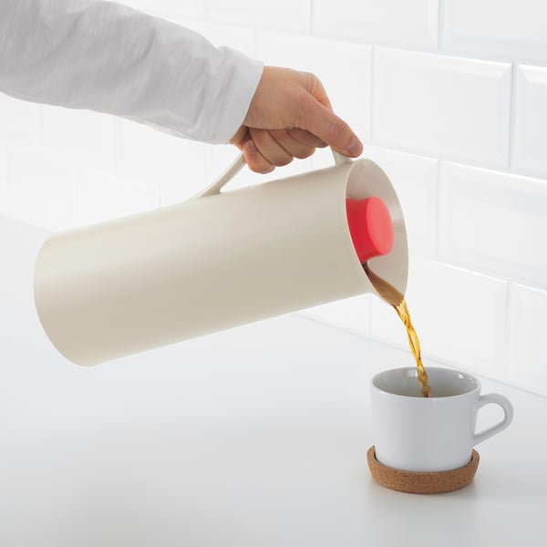 Pouring drink from flask into cup.