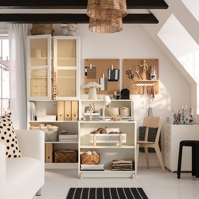 Home office with BILLY bookcase, craft tools, and wooden chair.
