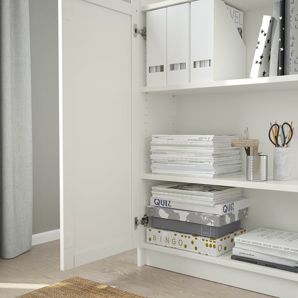 Bookshelf with adjustable shelves, holding files, books, and containers.