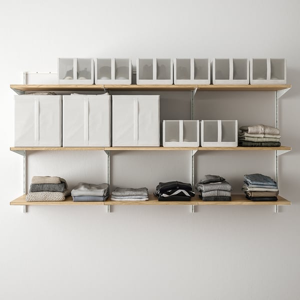 Modern wall-mounted shelves with foldable sections, holding neatly stacked clothes and transparent boxes.