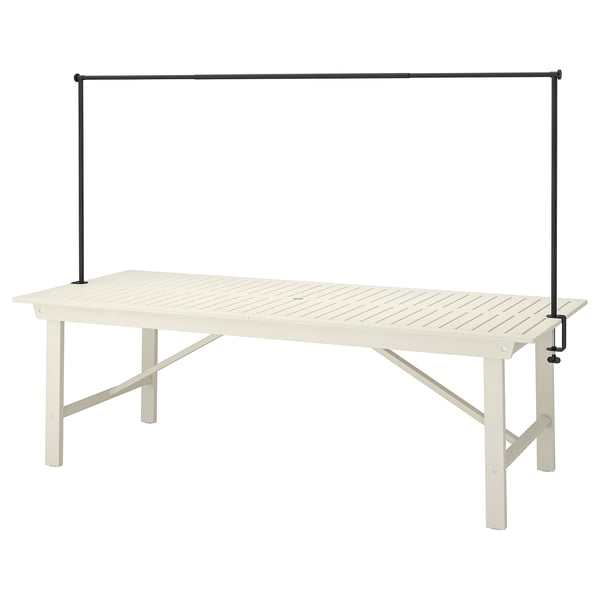 BONDHOLMEN outdoor table with black rod, light beige, rectangular, simple.