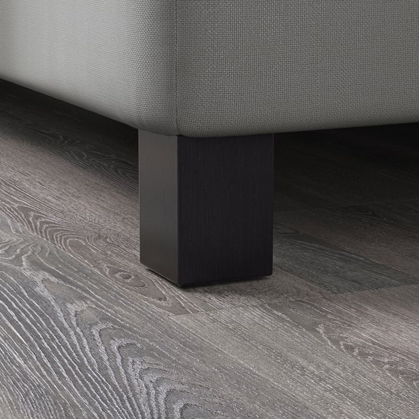 Close-up of modern wooden bed legs, smooth finish, sturdy solid wood construction.