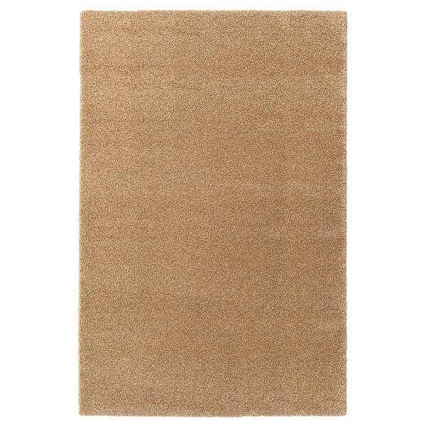 A plain beige rectangular rug, made of polypropylene and synthetic rubber, with a simple design.