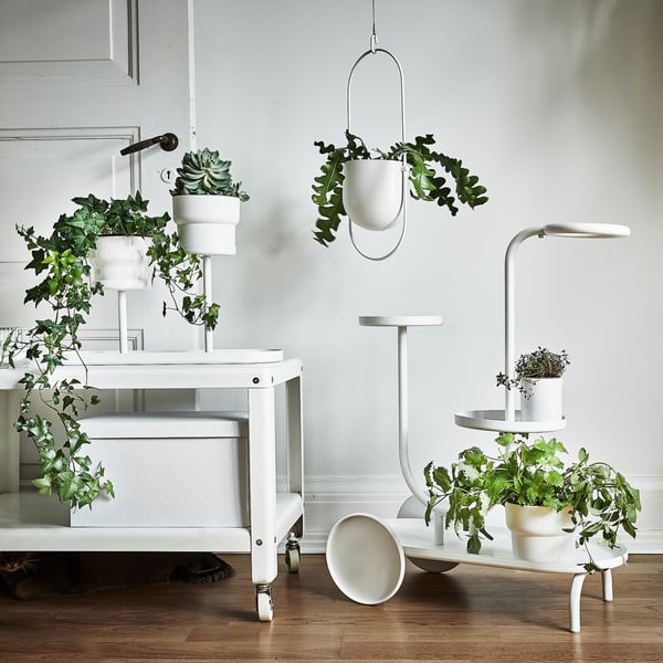 CHILISTRÅN white plant stand with multiple tiers and hanging planter, holding green plants. Modern design with powder-coated steel.