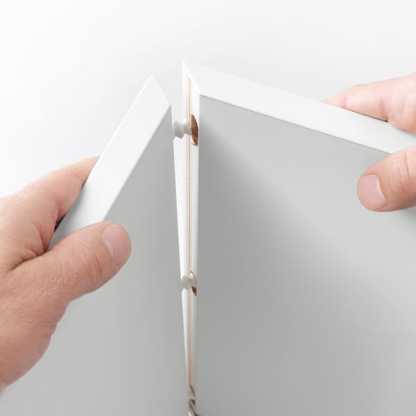 Hands assembling modular storage unit, showing quick-mount bracket.