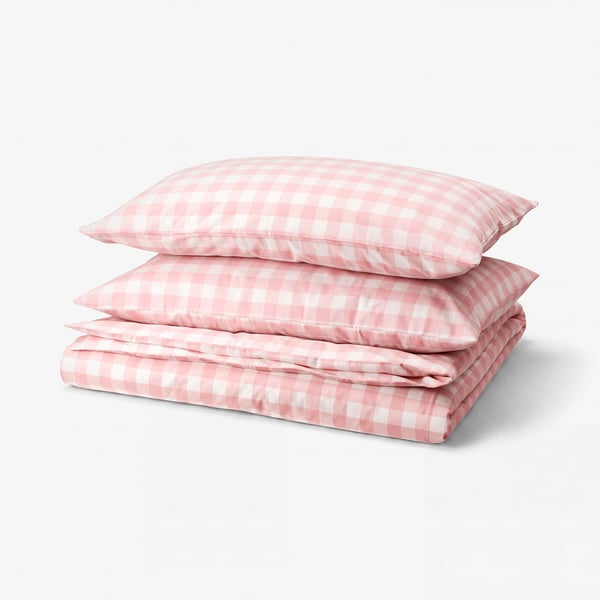 Pink and white chequered bedding set, folded neatly, made of organic cotton.