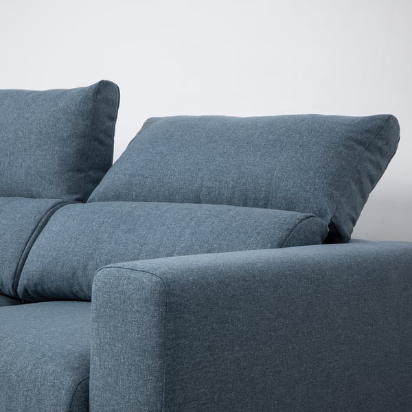Blue sofa with adjustable headrests and extendable chaise lounge for comfort.