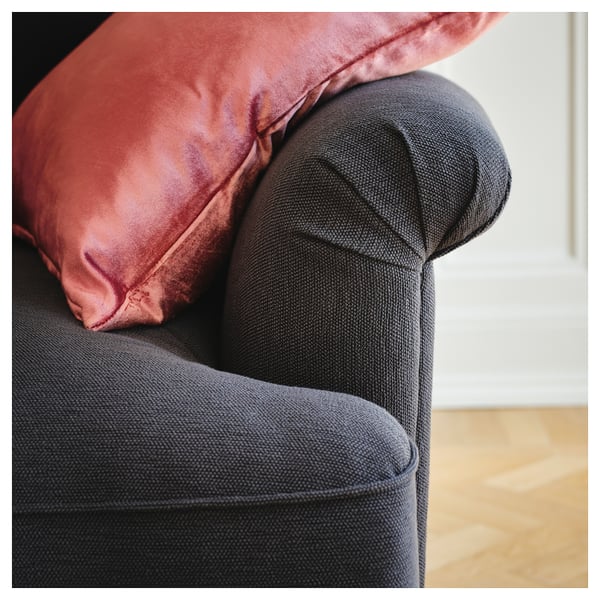 Dark grey ESSEBODA sofa with red cushion, cosy and modern design.