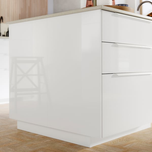 White glossy kitchen cabinet with sleek design, featuring shiny surface, multiple drawers, and wooden countertop.