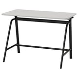 The GLADHÖJDEN desk in white with a black metal base. Modern design, adjustable height for sitting or standing, sleek edges, and durable materials.