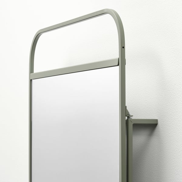 Modern mirror with integrated hooks, sleek green metal frame, sturdy design.