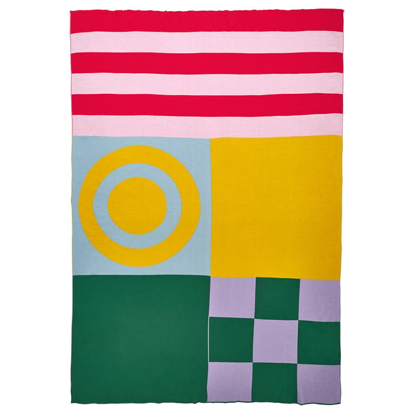 Colourful geometric blanket with stripes and circles. Yellow, pink, green, and red patterns. Cotton material, square shape.