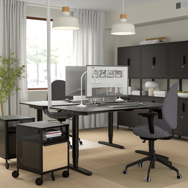 Modern office with HATTEFJÄLL ergonomic chair, adjustable desk, computer, and large window.