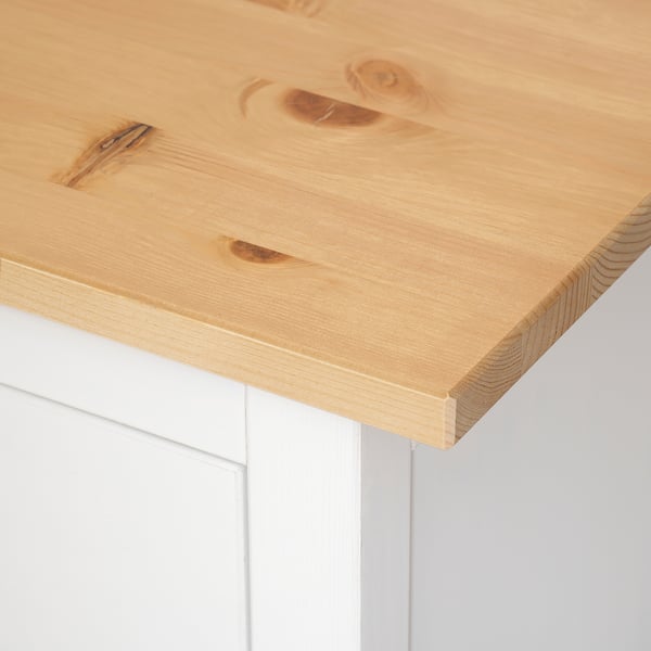 Close-up of a smooth, natural-finished wooden table top with clean edges. The grainy texture reveals the craftsmanship and quality of solid pine wood.