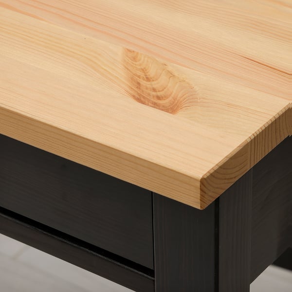 Close-up of sleek, light wood desk top, showcasing natural grain and smooth finish.