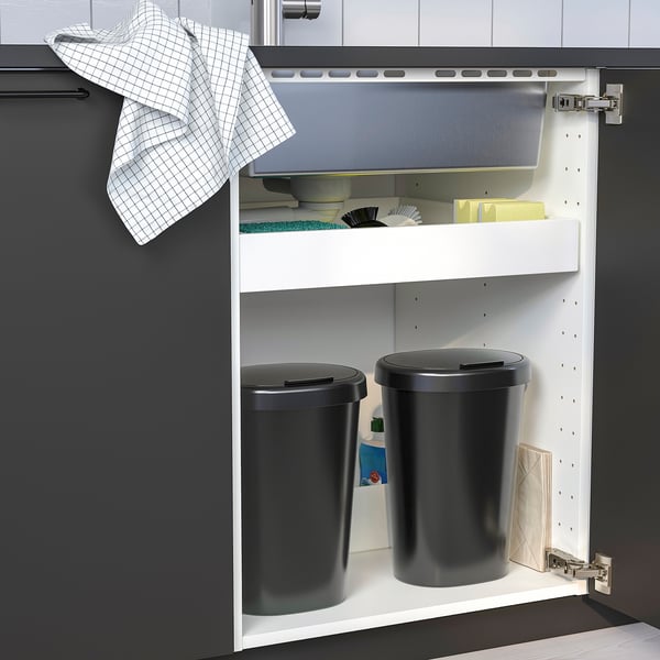 Kitchen cabinet with two rubbish bins for wet and dry waste, one with a lid.
