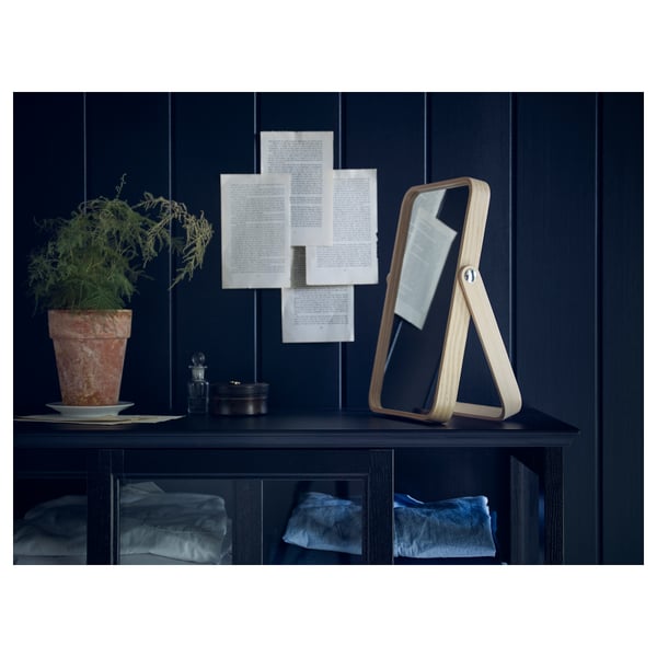 IKORNNES mirror on shelf with plant & clothes