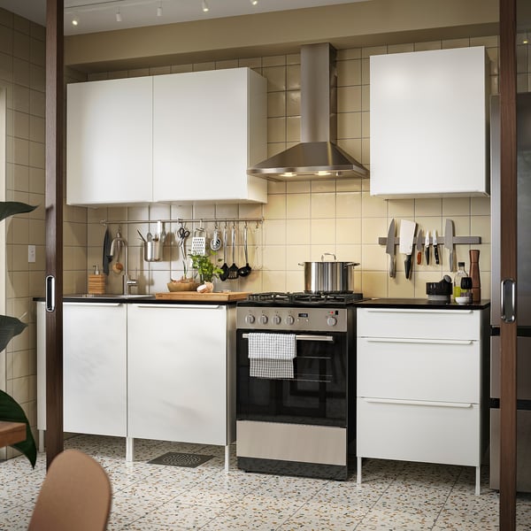 Modern white JÄRNBODA kitchen setup with sleek cabinets, stainless steel appliances, and efficient storage solutions.