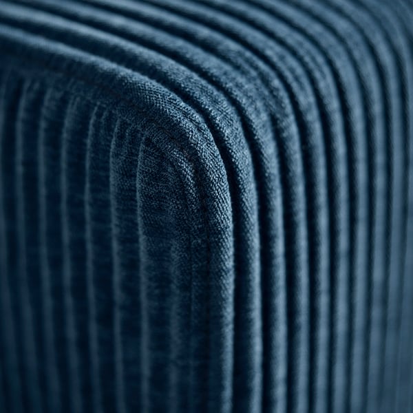 Sofa detail: plush, blue fabric with ribbed texture, showcasing high-quality comfort and craftsmanship.