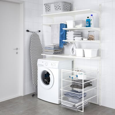 Laundry room with JONAXEL shelves holding towels, detergent, basket, washing machine, and ironing board.