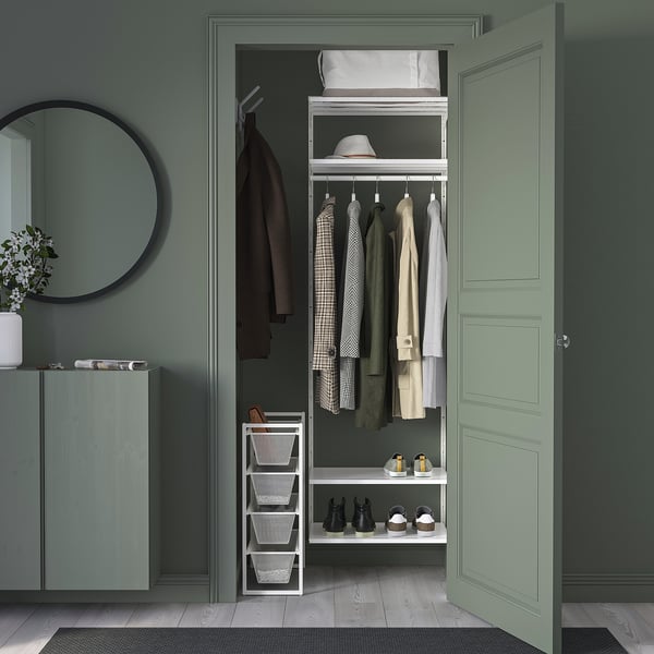 Green closet with JONAXEL storage, shelves, hanging bars, small cabinet, mirror, plant.
