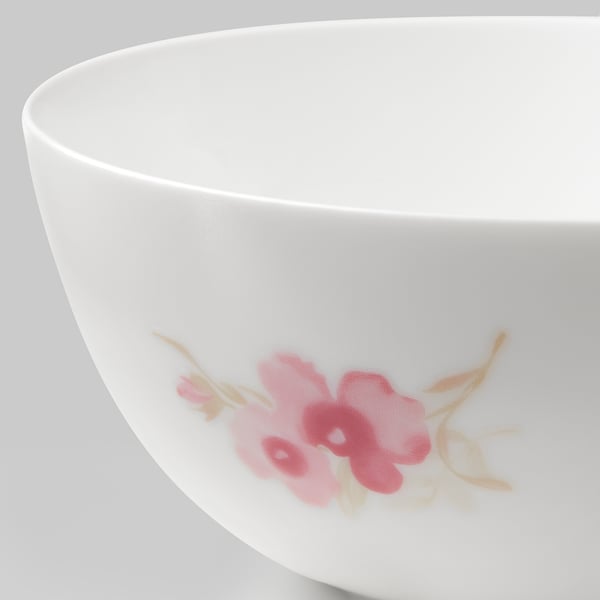 White bowl with delicate pink flowers, smooth edges, elegant design.