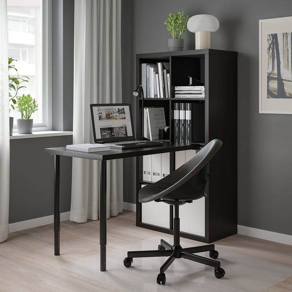Modern KALLAX desk, chair, lamp, books in cosy home office.