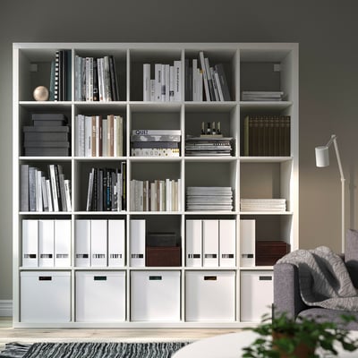 KALLAX white shelving unit with books & storage, dividing room, & cosy reading nook.