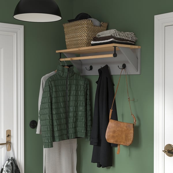 Green KALLSÖ furniture, jackets, & bag on hooks.