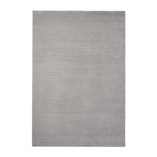 A KNARDRUP rug in light grey with a subtle shine. Its rectangular, thick, and soft, made from recycled polyester.