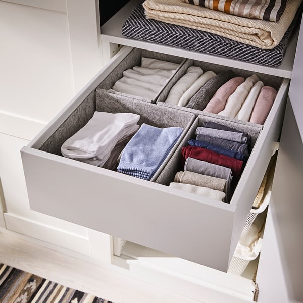 KOMPLEMENT drawer with grey felt boxes organising neatly folded socks and underwear.