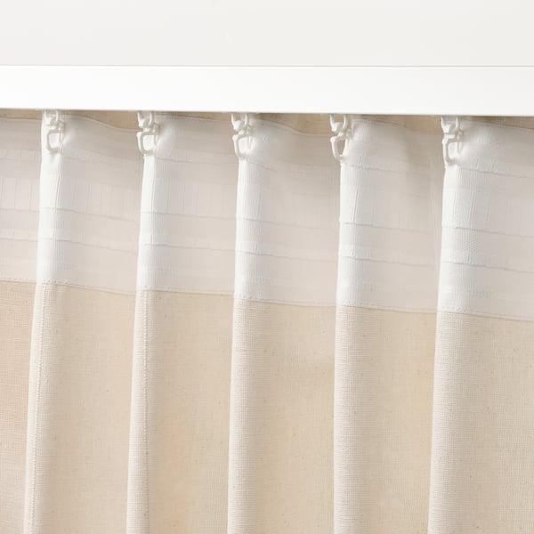 Off-white curtains with header tape for easy hanging. Curtains hang neatly with linear weave, suitable for privacy and daylight control.