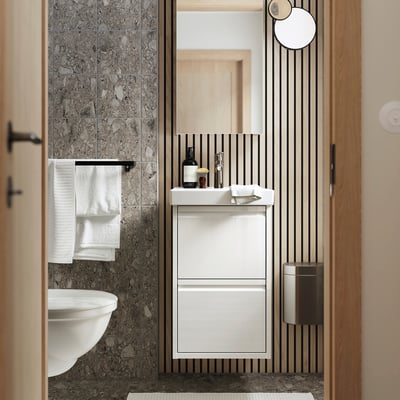 Modern bathroom with grey walls, white LETTAN mirror cabinet, sink, and towels.