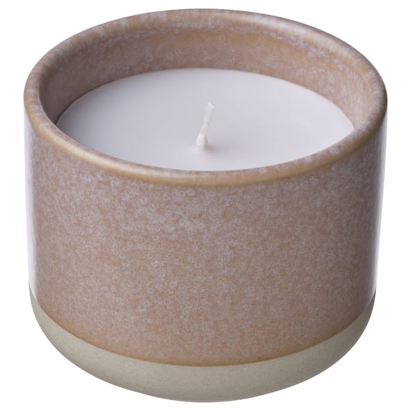 A cylindrical LUGNARE scented candle in a beige ceramic jar with a white candle core and wick.