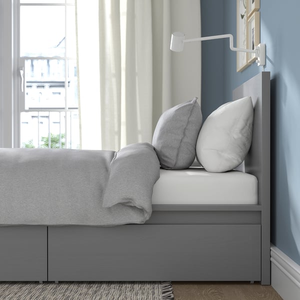 Modern bedroom with MALM bed, storage drawers, large window, wall lamp.
