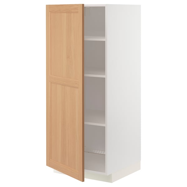 A partially open white and oak cabinet from the METOD kitchen system.