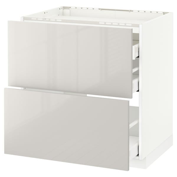 A white ikea METOD kitchen base cabinet with two drawers. It a modern, high-gloss design with smooth-running drawers.